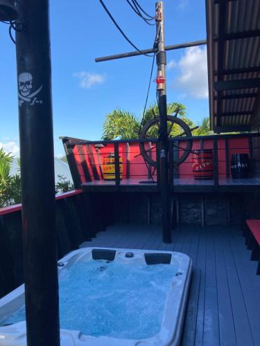 a hot tub on the deck of a house at Piton Bungalows Ecolodges in Deshaies