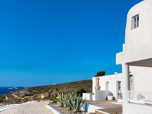 a white building with a view of the ocean at The Windmill Kimolos in Kimolos