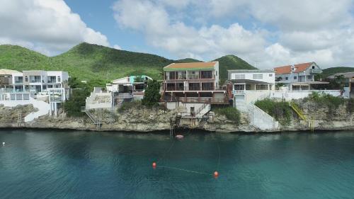 a group of houses on the side of a body of water at Lagun Ocean View Villa with Own Private Beach in Willemstad