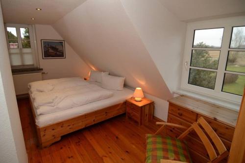 a small bedroom with a bed in a attic at Altes Backhaus in Groß Zicker