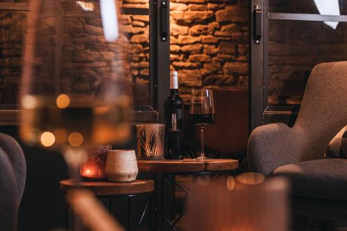 a table with two bottles of wine and a glass at Boutique-Hotel Anno 1910 in Wernigerode