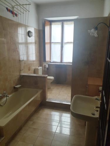 a bathroom with a tub and a toilet and a sink at La casa di Chicca in Turin