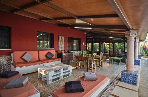 a living room with couches and a dining room at VILLA BASILIO in Constantina