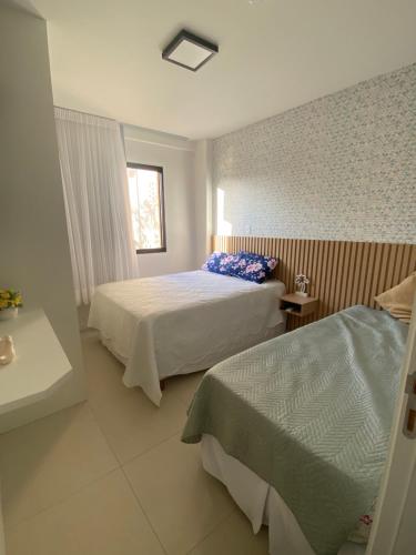 Ένα ή περισσότερα κρεβάτια σε δωμάτιο στο Guarajuba - Paraíso dos Coqueiros