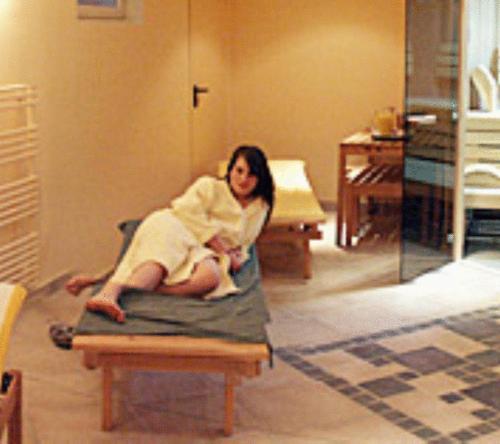 a woman holding a baby in a room at Gasthof Karlwirt in Sankt Andrä im Lungau