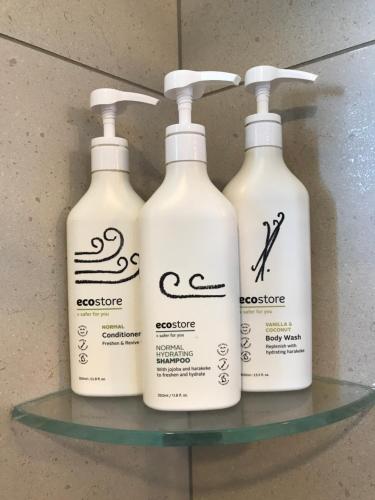 three bottles of lotion sitting on a glass shelf at Teviot View Accommodation in Amberley
