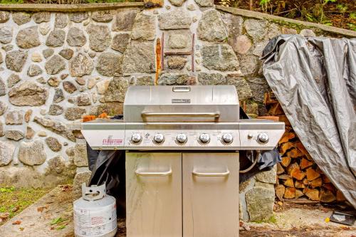 a stove sitting in front of a stone wall at 6 Bedroom House at Schroon River in Brant Lake