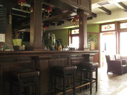 a bar in a restaurant with stools at Rio Hotel in Kardamaina