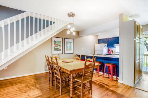 a kitchen and dining room with a wooden table and chairs at The Pirate Den in Edisto Beach
