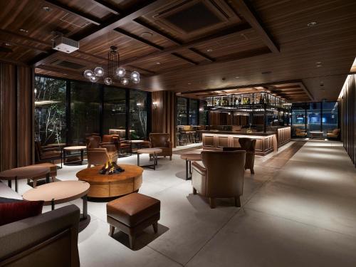 a restaurant with tables and chairs and a bar at Susukino Granbell Hotel in Sapporo