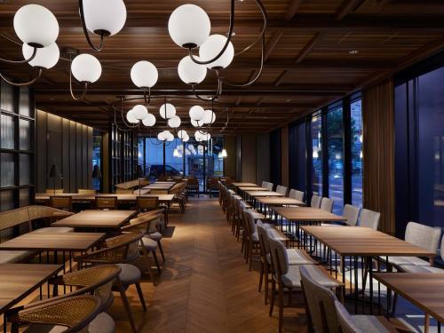 a row of tables and chairs in a restaurant at Susukino Granbell Hotel in Sapporo