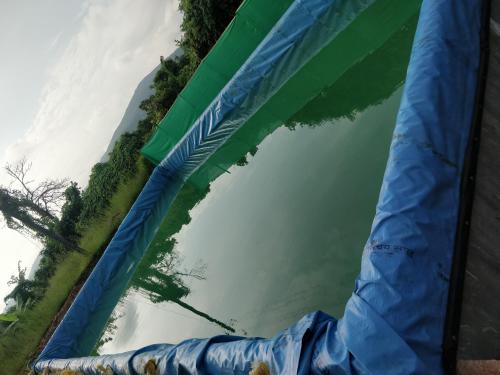 a blue and green inflatable structure in the water at Shree Samarth Farmhouse in Murud