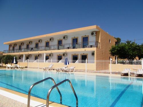 a large swimming pool in front of a building at Paraschos Studios Kos in Kardamaina