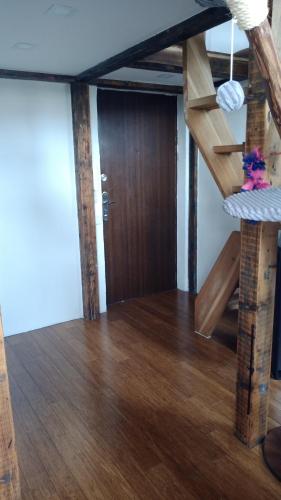 a room with a wooden staircase in a house at Bydlení v centru OV blízko Stodolní, bez výtahu in Moravská Ostrava