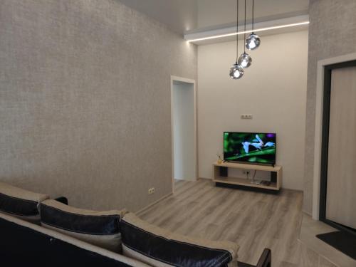 a waiting room with a tv and some chairs at Nice and plesant apartments on Evropeyska st. in Poltava