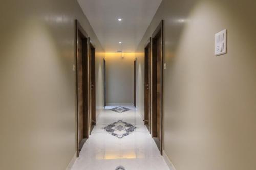a hallway with doors and a tile floor at Vashishth Guest House in Rishīkesh