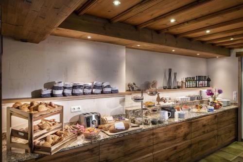a bakery counter with a lot of food on it at Hotel Neuwirt in Finkenberg