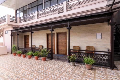 a row of potted plants on a patio at Vashishth Guest House in Rishīkesh