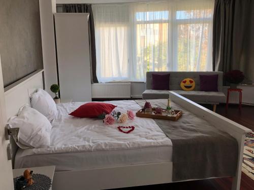 a bedroom with a large white bed with candles on it at Pensiunea Pont-Euxin in Constanţa