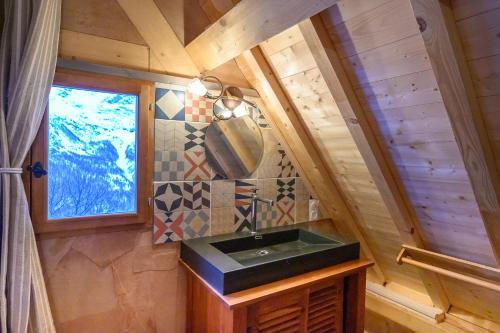 a bathroom with a sink in a wooden house at Petit Rochebrune in Orcières