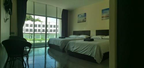 Postel nebo postele na pokoji v ubytování Hotel Pangkor SJ
