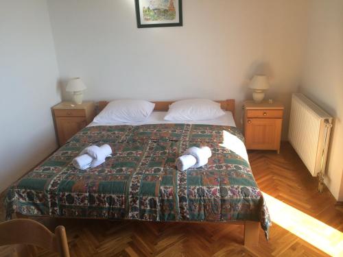 a bedroom with a bed with two towels on it at Guesthouse Lidija in Kukljica