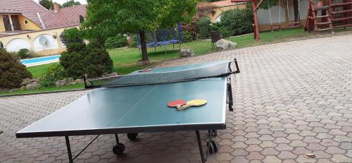 a ping pong table with two ping pong balls on it at Kenguru Panzió és Csárda in Hódmezővásárhely