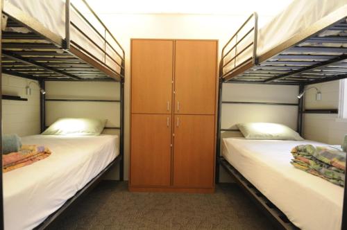 a bedroom with two bunk beds and a closet at Kangaroo Inn in Perth