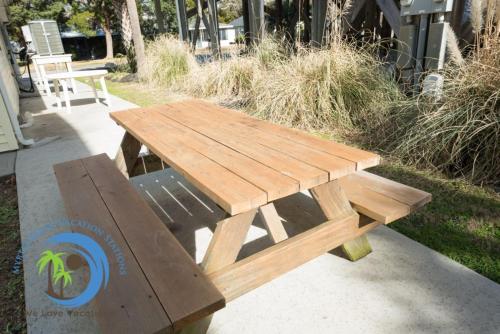 a wooden picnic table and bench on a sidewalk at Windy Hill Villa 2 - Beach Retreat in Myrtle Beach