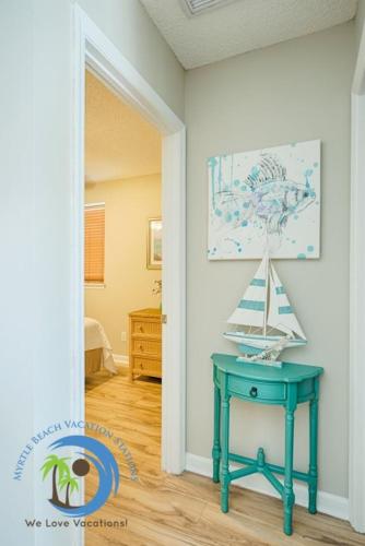 a room with a blue table with a boat on it at Windy Hill Villa 2 - Beach Retreat in Myrtle Beach