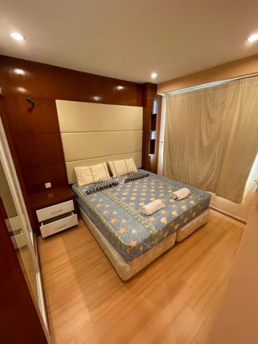 a bedroom with a bed and a wooden floor at GLORY BEACH RESORT NICE SEAVIEW HIGH STANDARD 3 BEDROOM in Port Dickson