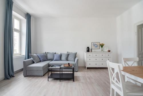 a living room with a couch and a table at Sophienne Apartments in Vienna