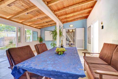 a dining room with a blue table and chairs at Studio 4827-3 for 4 Pers in Nerezine in Nerezine