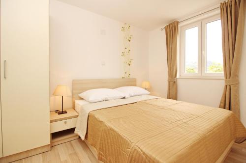 Ένα ή περισσότερα κρεβάτια σε δωμάτιο στο Apartments Gorica 2