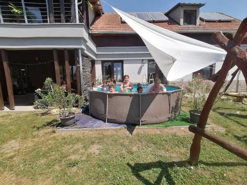 a family in a hot tub in a backyard at Silver Horse Ranch in Békés