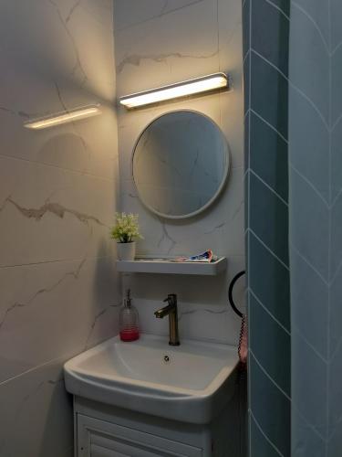 a bathroom with a sink and a mirror at Ubaid Homestay in Seremban