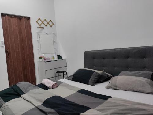 a bedroom with two beds and a mirror at Ubaid Homestay in Seremban
