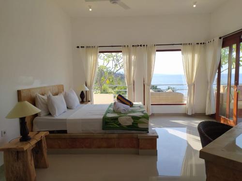 Un pat sau paturi într-o cameră la Ocean Resort Amed