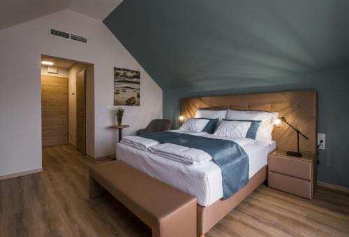 a bedroom with a large bed in a room at Kistücsök Food & Room in Balatonszemes