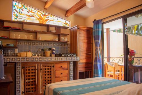 a kitchen with a table and a stained glass window at Hotel Casamar Suites in Puerto Escondido