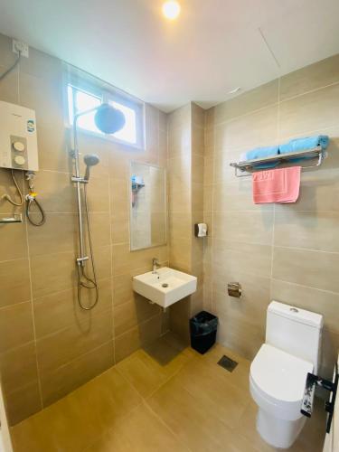 a bathroom with a toilet and a sink and a shower at Seaview Apartment in Kuah
