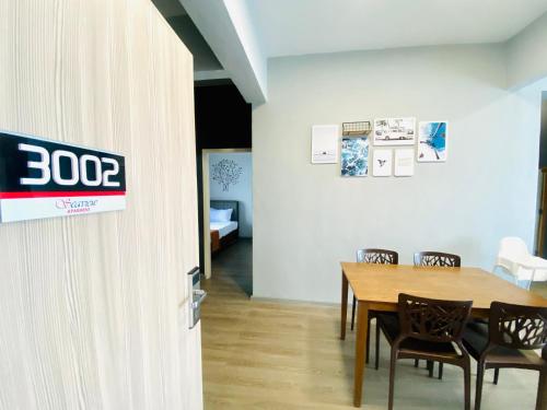 a dining room with a table and chairs at Seaview Apartment in Kuah