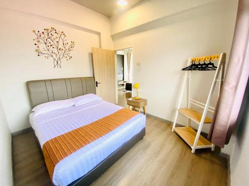 a bedroom with a bed and a dresser in it at Seaview Apartment in Kuah