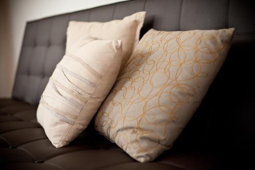 two pillows sitting on top of a couch at Bacher Ferienwohnungen in Virgen