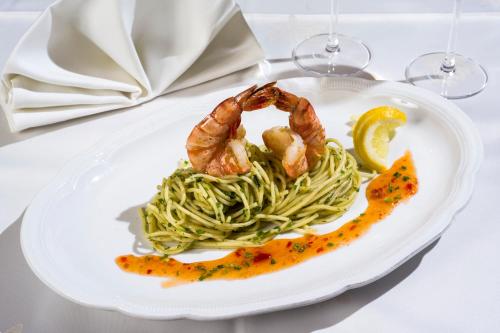 a plate with shrimp and pasta on a table at Loipenstubn in Brixen im Thale