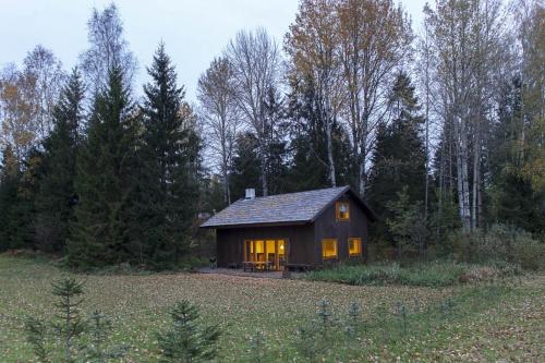a small house in the middle of a field at Kivi Talu Country Hotel in Otepää