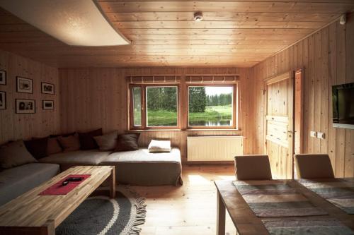 a living room with a couch and a table at Kivi Talu Country Hotel in Otepää