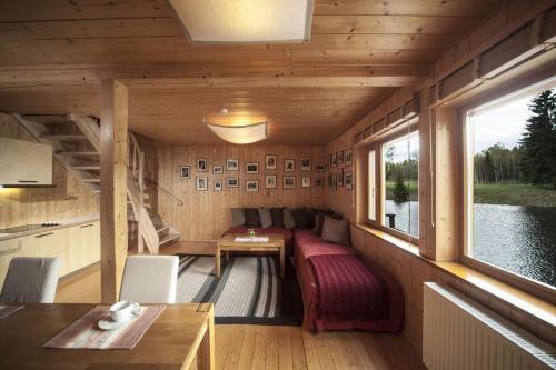a cabin with a bed and a table in it at Kivi Talu Country Hotel in Otepää