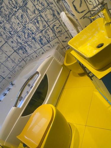 a yellow car with its door open next to a ceiling at Ziggla Luxury Apartments in London