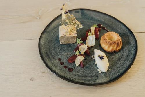 a plate with cheese and other foods on it at Landgasthof Adler in Breisach am Rhein